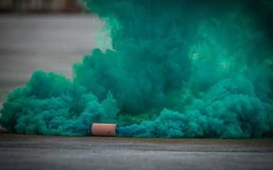 colorful green smoke bombs action in showing