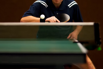 table tennis player returning, focus at the blade