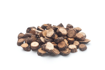 Sliced ​​of Red peony roots on white background. Chinese herbal medicine. © koosen