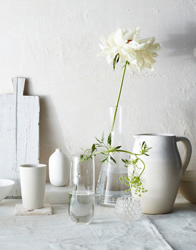 Still life of vases and white objects with flower