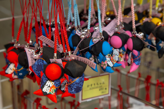 Sarubobo Dolls on sell at souvenir shop. Sarubobos are human shaped dolls with no facial and be Japanese amulet, particularly associated with town of Takayama.