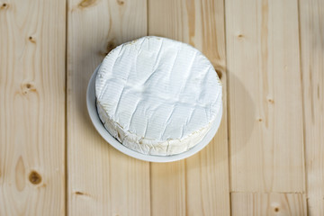 Fototapeta na wymiar French soft cheese Coulommiers of the Brie family with a bloomy rind white in color and in the shape of a disc