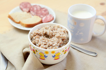 Breakfast-buckwheat porridge with sandwiches and milk