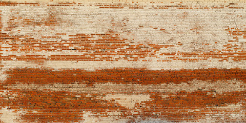 Wide texture of old red brickwork. Rough weathered brick wall with peeling and cracked and cement. Uneven grungy surface of the blocks. Perfect for urban background and grunge design.