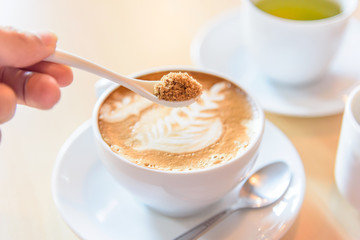 Add sugar to hot coffee