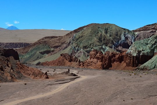 Desert landscape with dirt road in the Rainbow Valley, Valle Arcoiris, near San Pedro de Atacama, Region de Antofagasta, Chile, South America