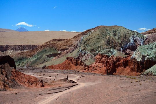 Desert landscape with dirt road in the Rainbow Valley, Valle Arcoiris, near San Pedro de Atacama, Region de Antofagasta, Chile, South America