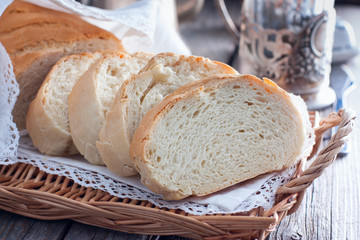 Homemade white bread in a rustic style, sliced, horizontal