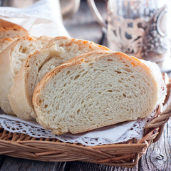Homemade white bread with a cup of tea in the background, selective focus
