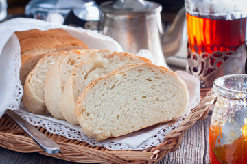 Homemade white bread in a rustic style, sliced, horizontal