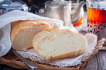 Homemade white bread in a rustic style, sliced, horizontal