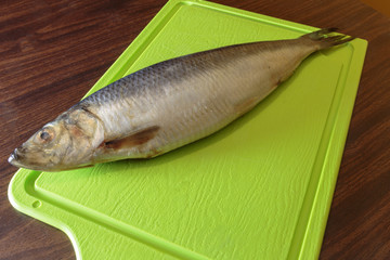 Salted herring on a cutting board.