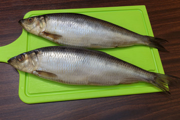 Salted herring on a cutting board.