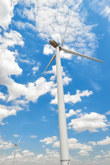 The wind generator is in bright cloudy sky. Eco energy concept.