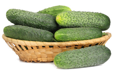 Green cucumbers in a basket isolated on white