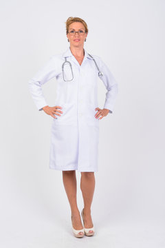 Full body shot of happy mature woman doctor smiling
