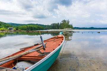Fototapeta na wymiar Wooden fishery boat on sea beach