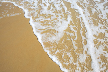 Fototapeta na wymiar Little Sea Wave in the Sunny Day Beach