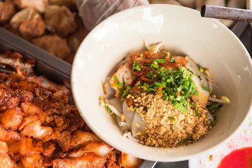 Top view of a bowl of spicy Thai Tom Yum noodle soup with pork.Bangkok,thailand.