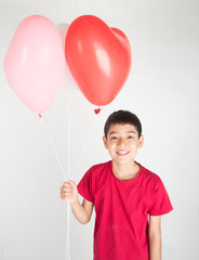 Fototapeta na wymiar Boy sibling with balloon heart shape of love