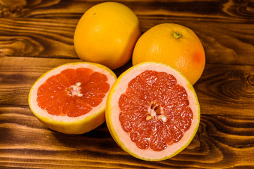 Fototapeta na wymiar Ripe juicy grapefruit on a wooden table