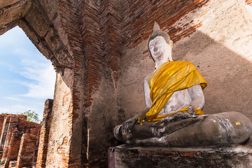 Old buddha statue with old wall brick of Wat Nakhon Luang Tample,Prasat Nakhon Luang in Ayutthaya,Thailand.