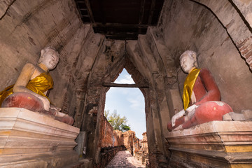 Old buddha statue with old wall brick of Wat Nakhon Luang Tample,Prasat Nakhon Luang in...