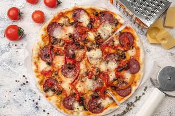 pizza with salami top view, ingredients, light background