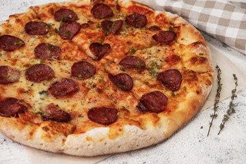 pizza with salami, ingredients, light background, close-up