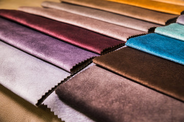 Colorful and bright fabric samples of furniture and clothing upholstery. Close-up of a palette of textile abstract stripes of different colors