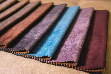 Colorful and bright fabric samples of furniture and clothing upholstery. Close-up of a palette of textile abstract stripes of different colors
