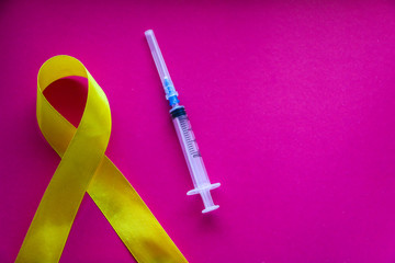 golden ribbon and medicine. concept - a symbol of childhood cancer, pediatric oncology