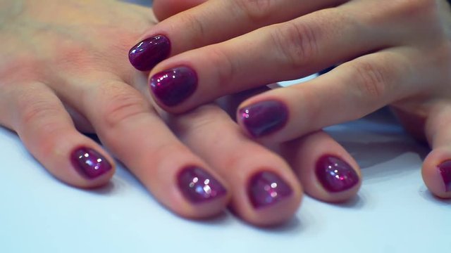 well-groomed hands of a young woman with a beautifully made modern bright manicure.nails painted bright red.close-up.