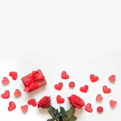 Valentine's day greeting card. Composition with gift, roses, red hearts. Top view. Copy space.
