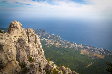 A beautiful landscape on the top of Mount Ai Petri, the town of Gaspra and the Black Sea in Crimea, background with vignette.