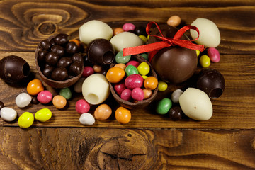 Easter composition with chocolate eggs on wooden background