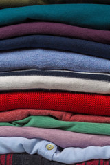 Stacks of folded clothes, close up .