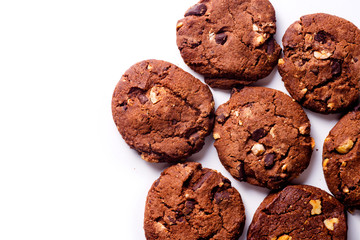Overhead closeup image of chocolate cookies on white background with copy space