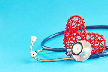 stethoscope and red heart on blue background, medical care concept, staff medical insurance
