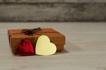 Gift box and heart shape decoration on a wooden table