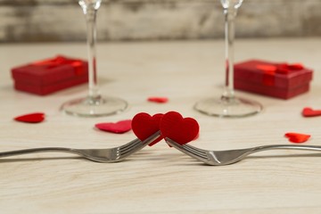 Heart shape decorations with fork on a wooden table
