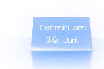 Termin am 26. Juni - blauer Zettel mit Notiz