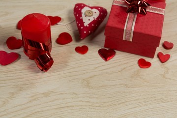 Gift boxes and heart shape decorations on wooden table