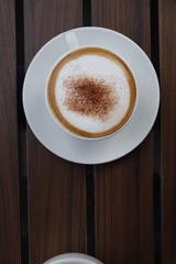Hot coffee on wood background.