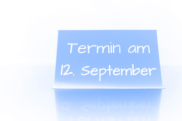 Termin am 12. September - blauer Zettel mit Notiz