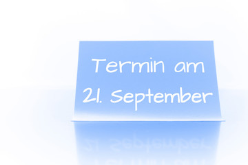 Termin am 21. September - blauer Zettel mit Notiz