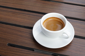 Hot coffee on wood background.