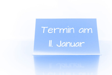 Termin am 11. Januar - blauer Zettel mit Notiz