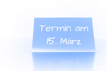 Termin am 15. März - blauer Zettel mit Notiz