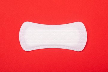 Sanitary napkin isolated on red background with copyspace